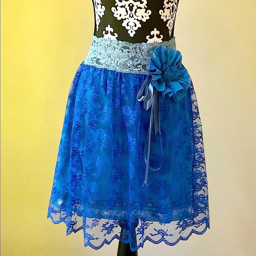 Blue skirt with lace outer layer. Bow and ribbon